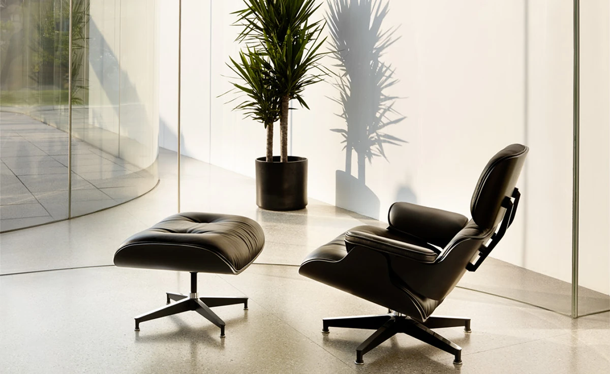 Curved armrest in black leather on an Eames lounge chair replica