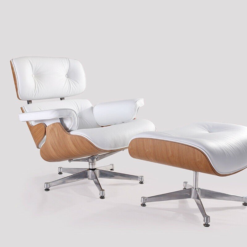 Left angle view of the white Eames lounge chair and ottoman, ash wood and chrome base