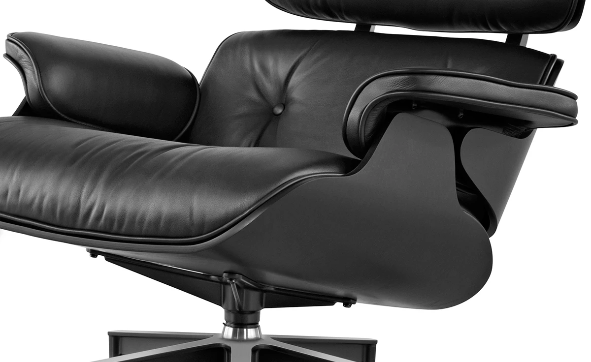 Side profile of the all black Eames lounge chair replica, showing the reclined shell angle